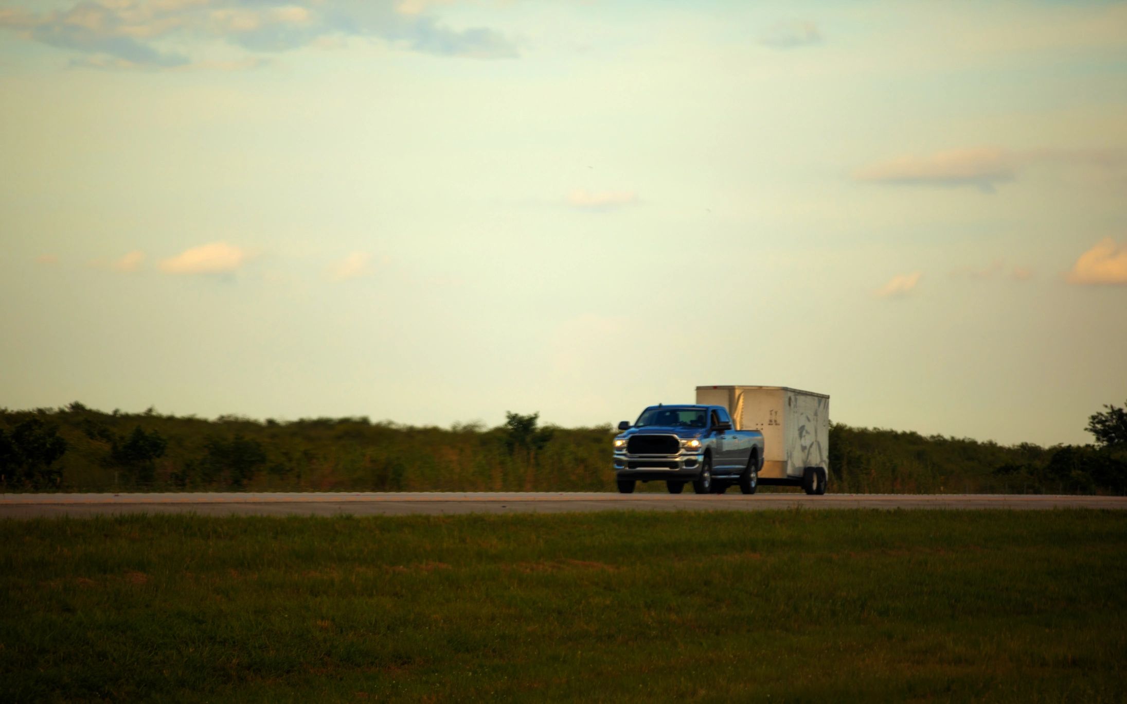 White Ram 2500 pickup truck hauling a small trailer